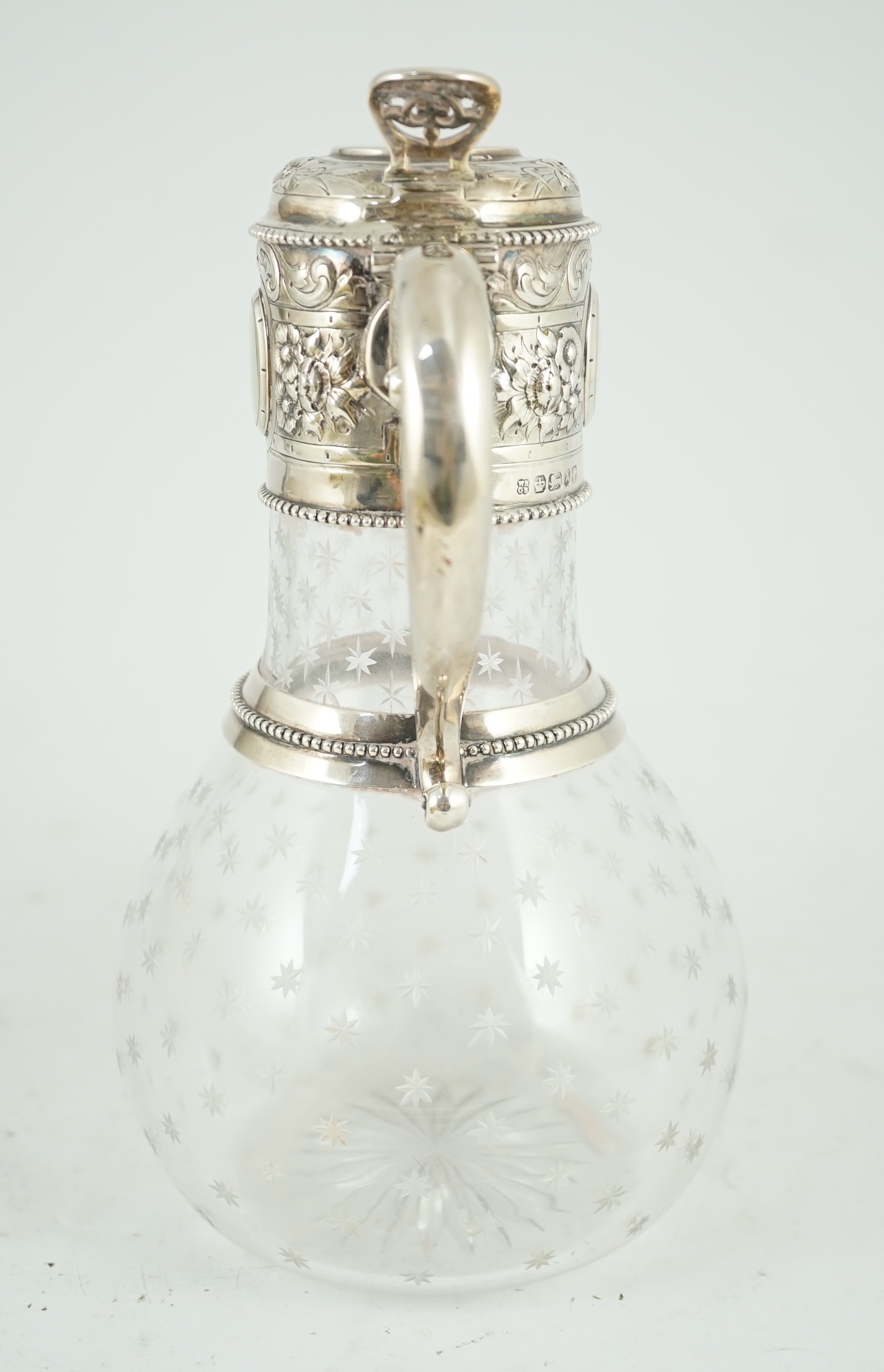A Victorian embossed silver mounted engraved glass claret jug, the glass later, the silver, Sheffield, 1868, by William and George Sissons
